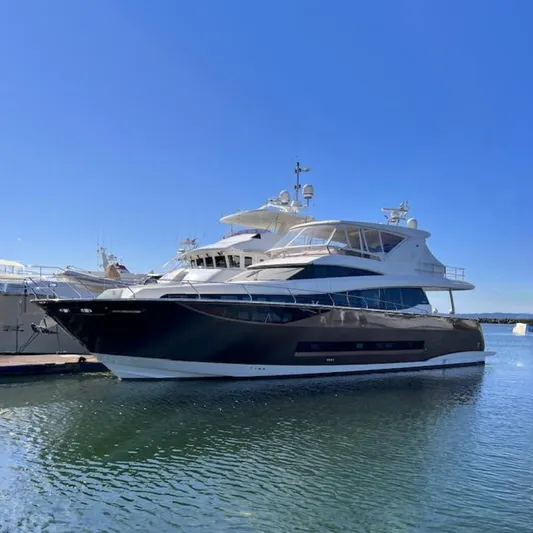  Yacht Photos Pics Luxurious 2016 Prestige 750 yacht docked in a serene marina.
