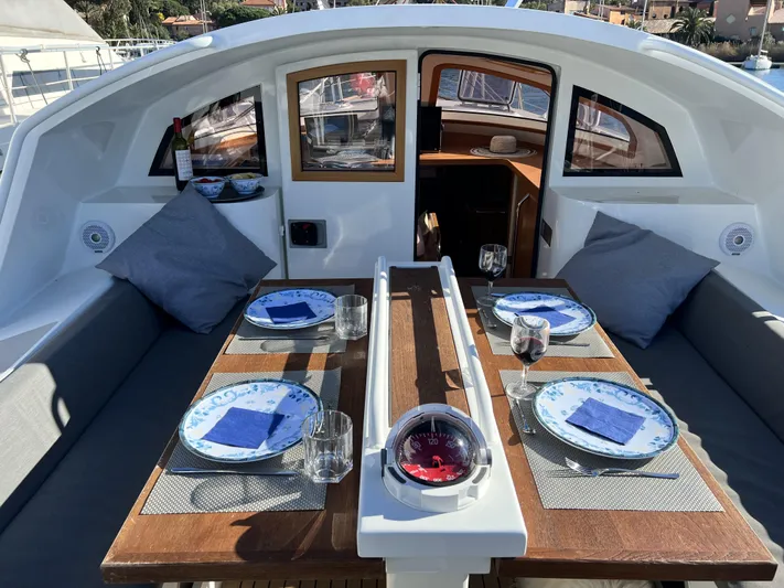 Maquis Yacht Photos Pics Elegant dining setup on Boreal 55 OC yacht, 2020 model, with nautical-themed tableware.