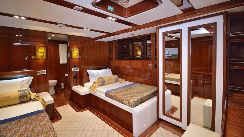  Yacht Photos Pics Luxurious cabin interior of 2012 Custom Motorsailor with elegant wood finish and twin beds.