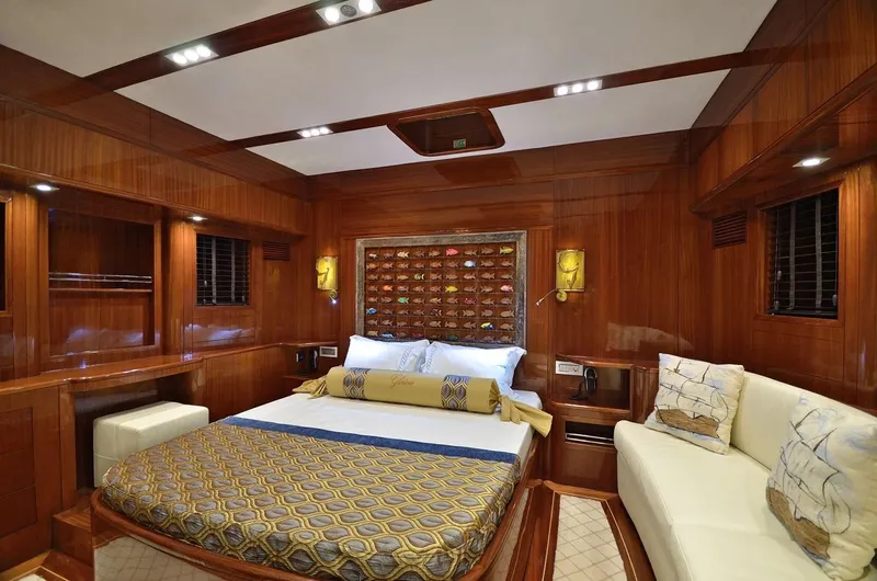  Yacht Photos Pics Luxurious cabin interior of 2012 Custom Motorsailor with wood paneling and elegant bedding.