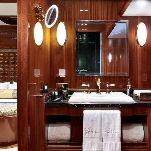  Yacht Photos Pics Luxurious bathroom with wood paneling, elegant fixtures, and plush towels on a 2012 Custom Motorsailor.