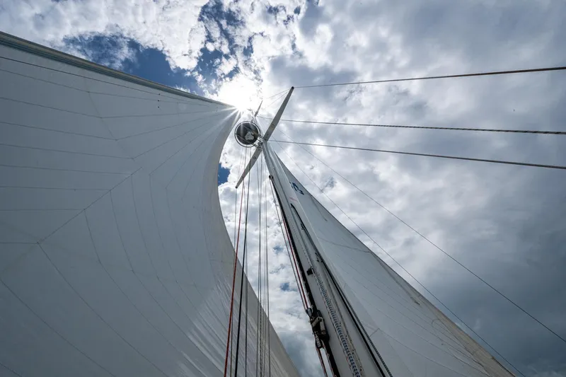 Ghost Yacht Photos Pics Sailboat mast and sails against cloudy sky, Hinckley Sou'wester Stoway Sloop, 2000.