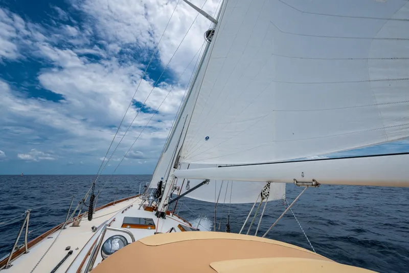 Ghost Yacht Photos Pics Hinckley Sou'wester Stoway Sloop sailing on open sea under clear blue sky.