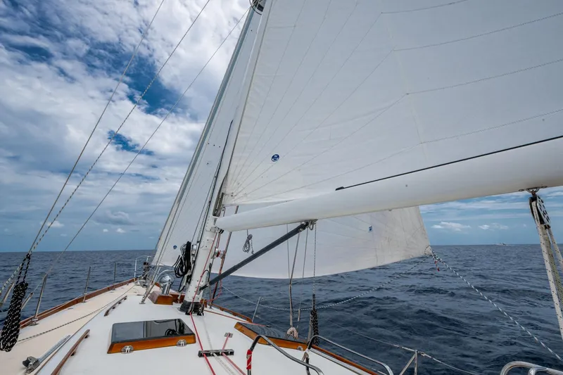 Ghost Yacht Photos Pics Hinckley Sou'wester Stoway Sloop sailing on open sea under cloudy sky, 2000 model.