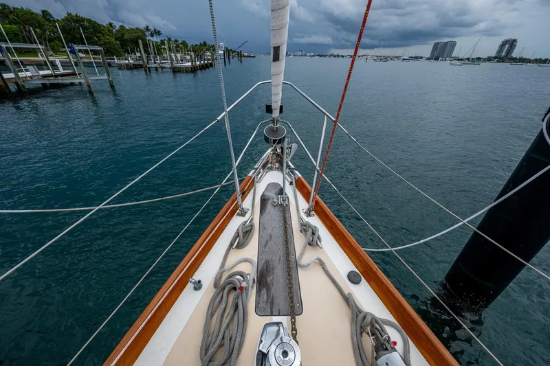 Ghost Yacht Photos Pics Bow view of 2000 Hinckley Sou'wester Stoway Sloop in a marina, under cloudy skies.