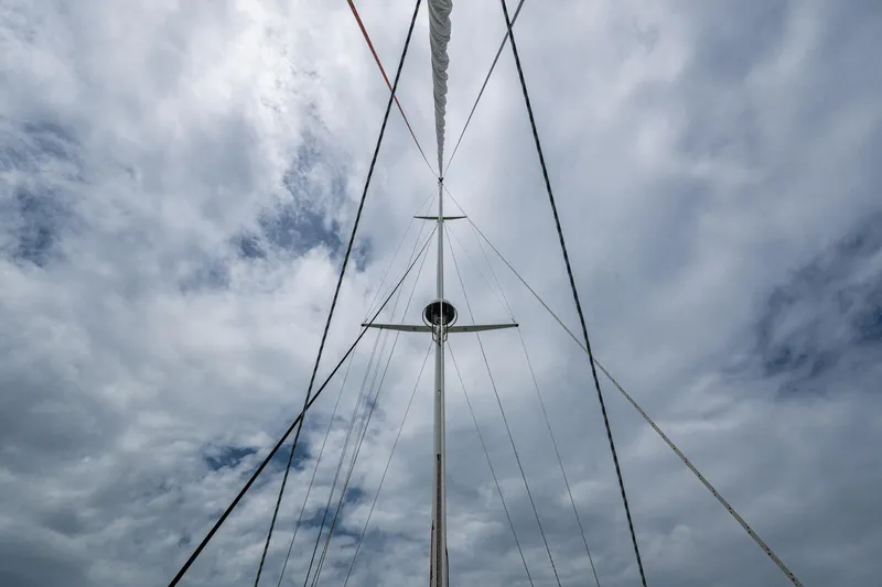 Ghost Yacht Photos Pics Mast and rigging of 2000 Hinckley Sou'wester Stoway Sloop against cloudy sky.