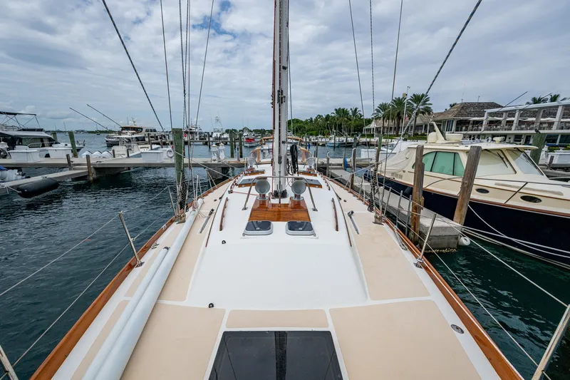 Ghost Yacht Photos Pics Hinckley Sou'wester Stoway Sloop 2000 docked at marina, surrounded by boats.