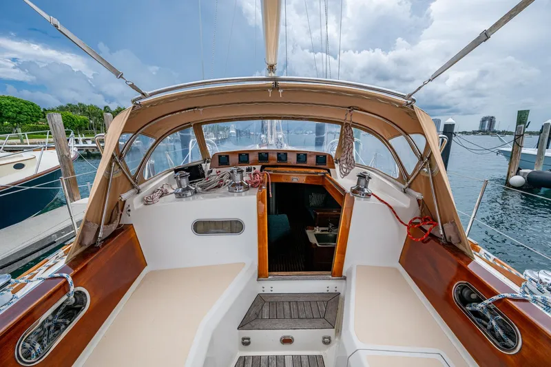 Ghost Yacht Photos Pics Hinckley Sou'wester Stoway Sloop 2000 cockpit with tan canopy, docked at marina.