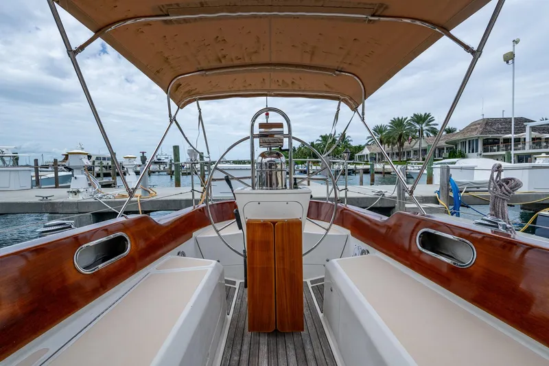 Ghost Yacht Photos Pics Hinckley Sou'wester Stoway Sloop 2000, elegant cockpit view at marina, wooden accents, canopy overhead.
