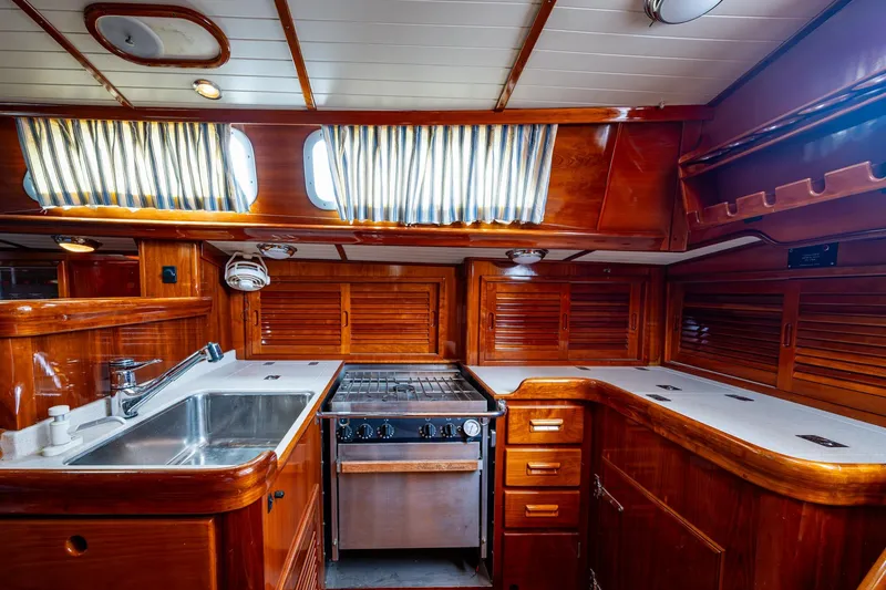 Ghost Yacht Photos Pics Luxurious wooden interior of 2000 Hinckley Sou'wester Stoway Sloop yacht kitchen.