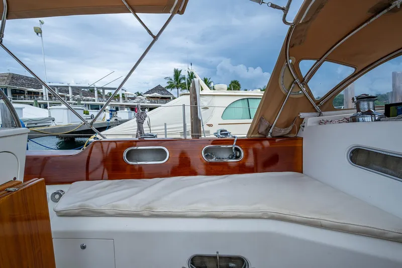 Ghost Yacht Photos Pics Hinckley Sou'wester Stoway Sloop 2000 cockpit with wooden trim and marina view.