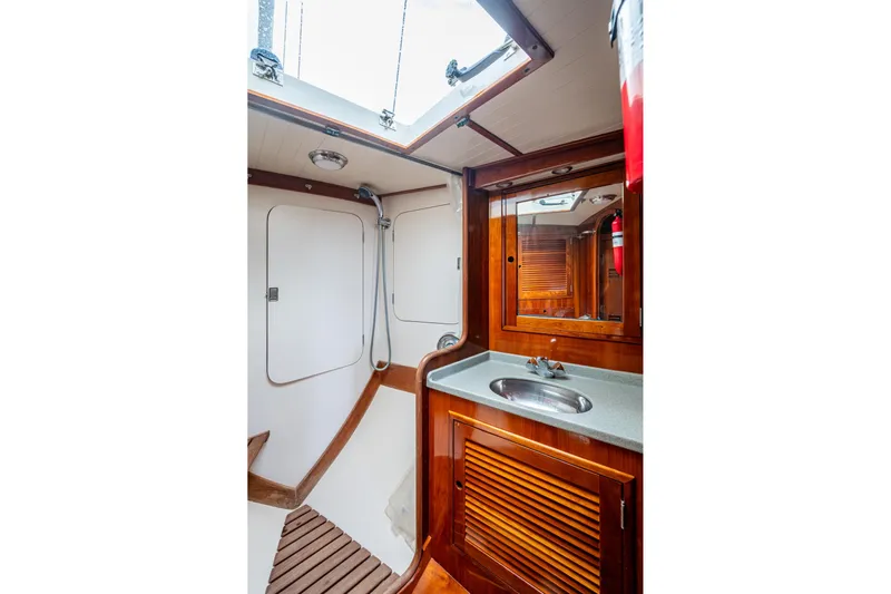 Ghost Yacht Photos Pics Hinckley Sou'wester Stoway Sloop 2000 yacht interior, featuring a wooden bathroom with sink and shower.