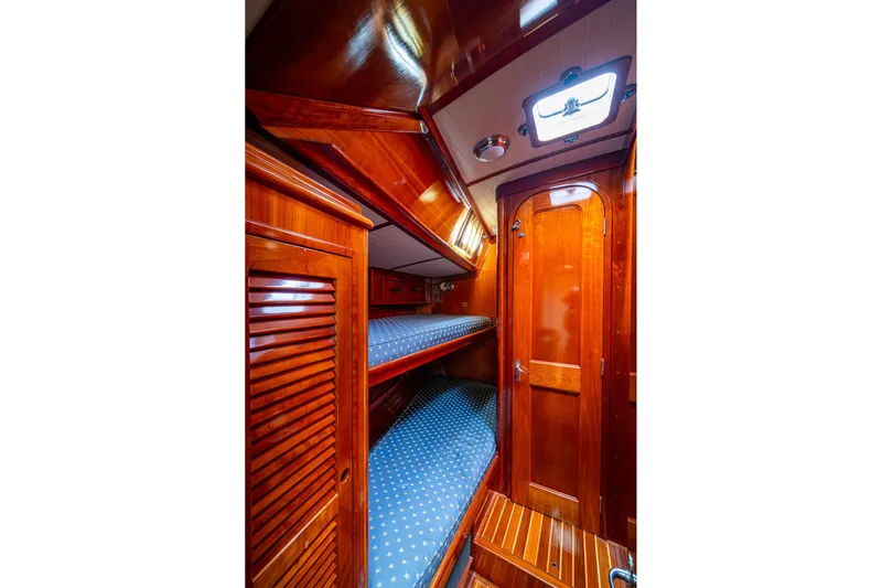 Ghost Yacht Photos Pics Luxurious wooden interior of 2000 Hinckley Sou'wester Stoway Sloop with cozy bunk beds.