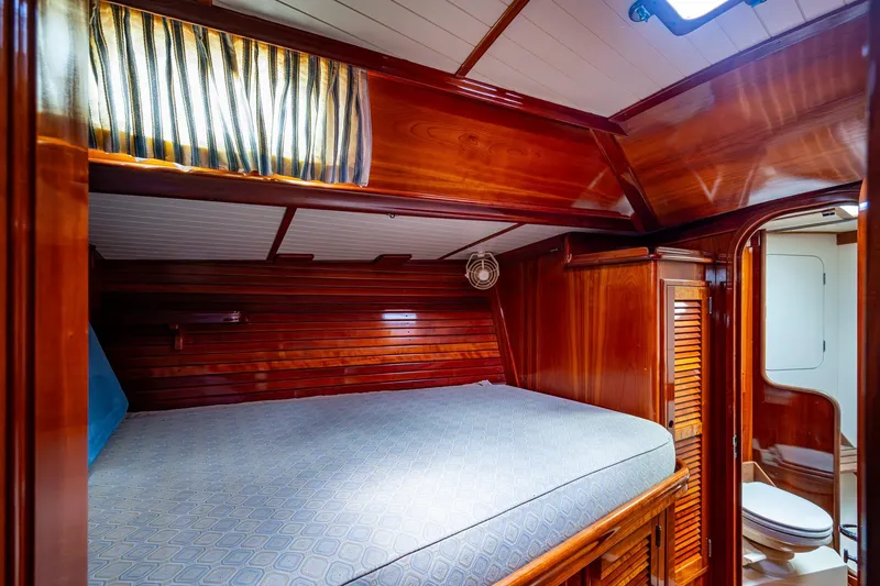 Ghost Yacht Photos Pics Hinckley Sou'wester Stoway Sloop 2000 interior cabin with wooden finish and cozy bed.