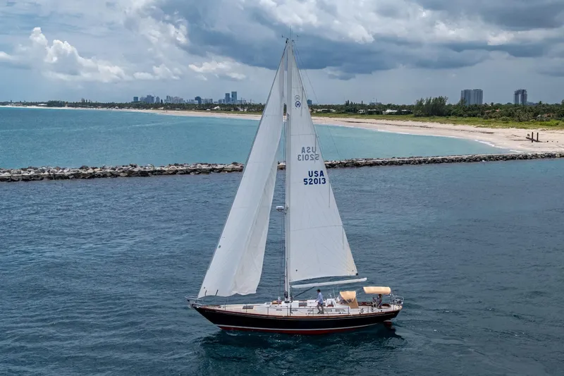 Ghost Yacht Photos Pics Hinckley Sou'wester Stoway Sloop sailing near a scenic coastline, 2000 model.