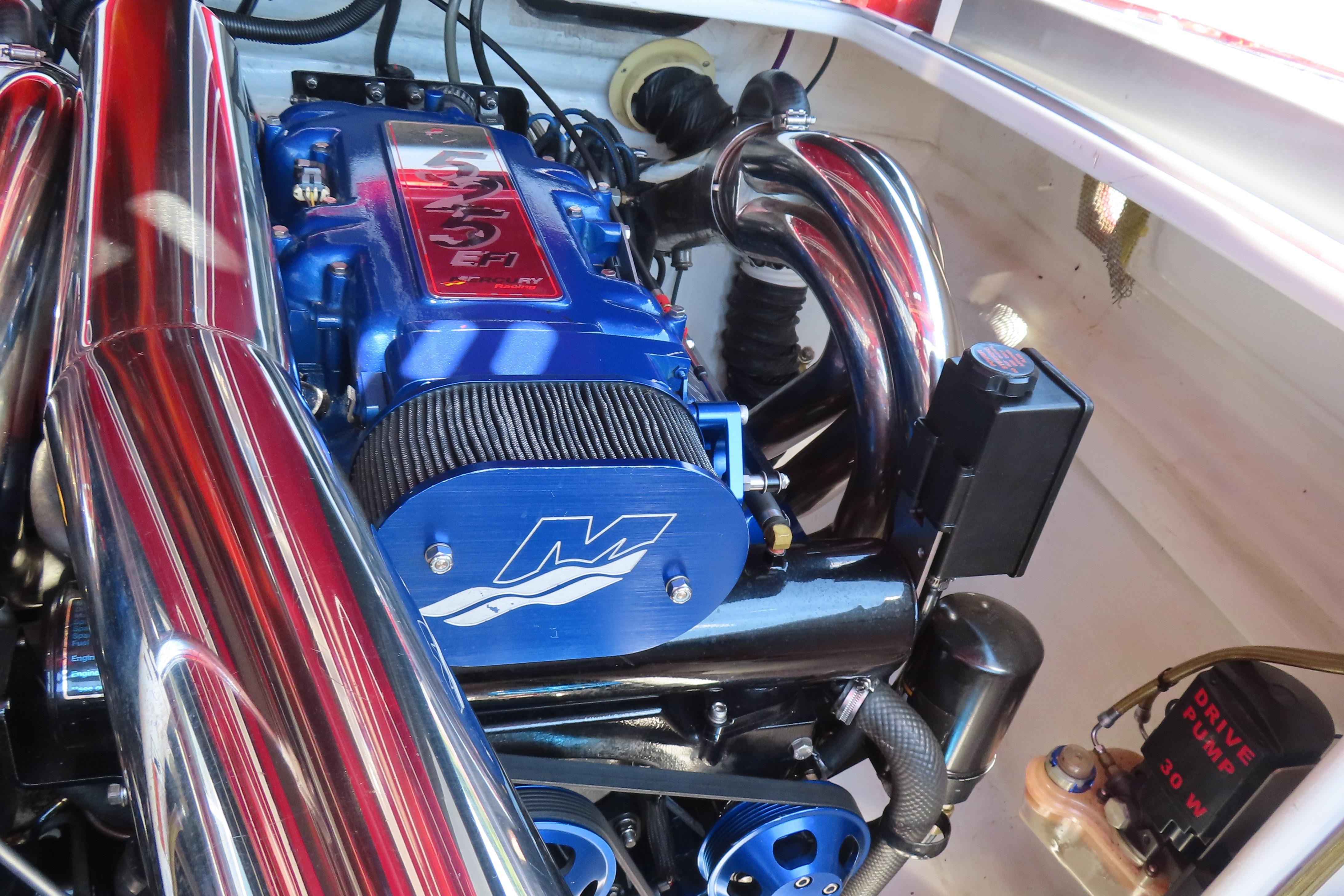 Engine of a 2004 Outerlimits 42 Legacy boat, featuring a blue and chrome design.