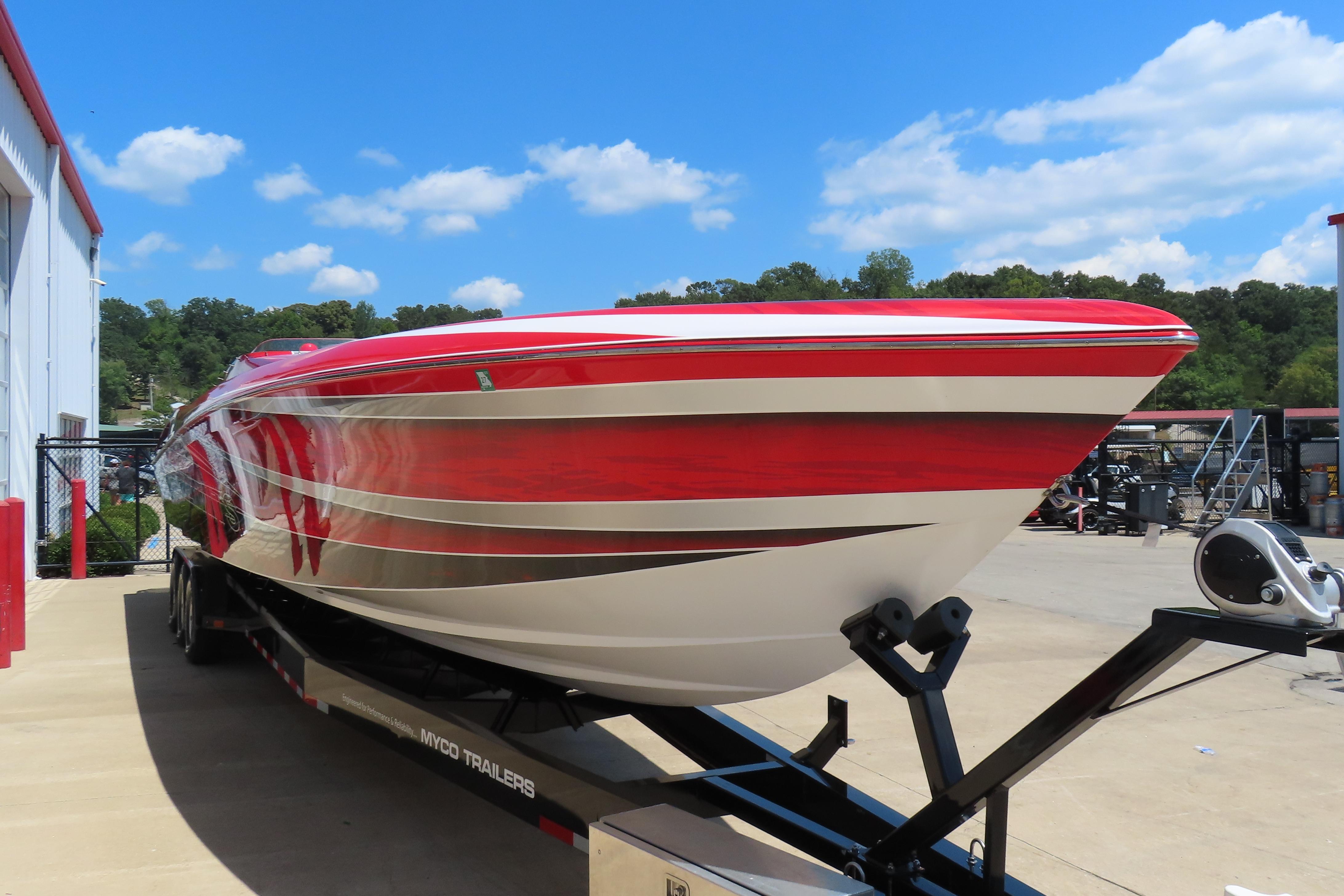 2004 Outerlimits 42 Legacy speedboat with red and white design on a trailer.