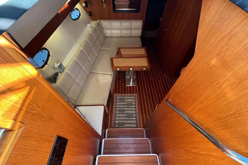  Yacht Photos Pics Luxurious interior of 2002 Tiara Yachts 4100 Open, featuring wood finishes and plush seating.