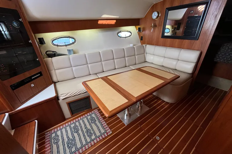  Yacht Photos Pics Luxurious interior of 2002 Tiara Yachts 4100 Open with elegant seating and wooden accents.