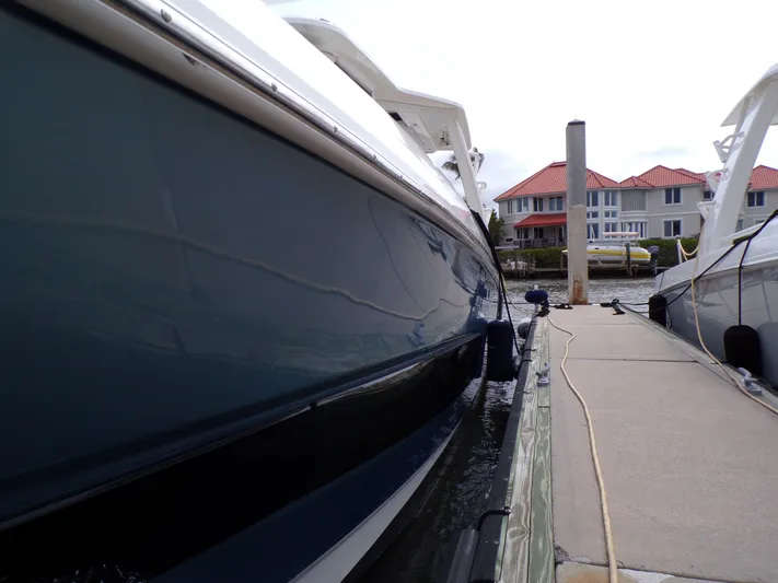  Yacht Photos Pics 2018 Boston Whaler 420 docked with houses in the background.