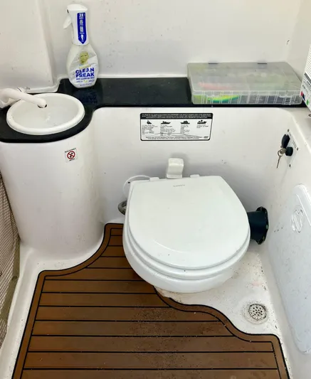  Yacht Photos Pics 2018 Sea Fox 288 Commander boat bathroom with toilet, sink, and cleaning supplies.