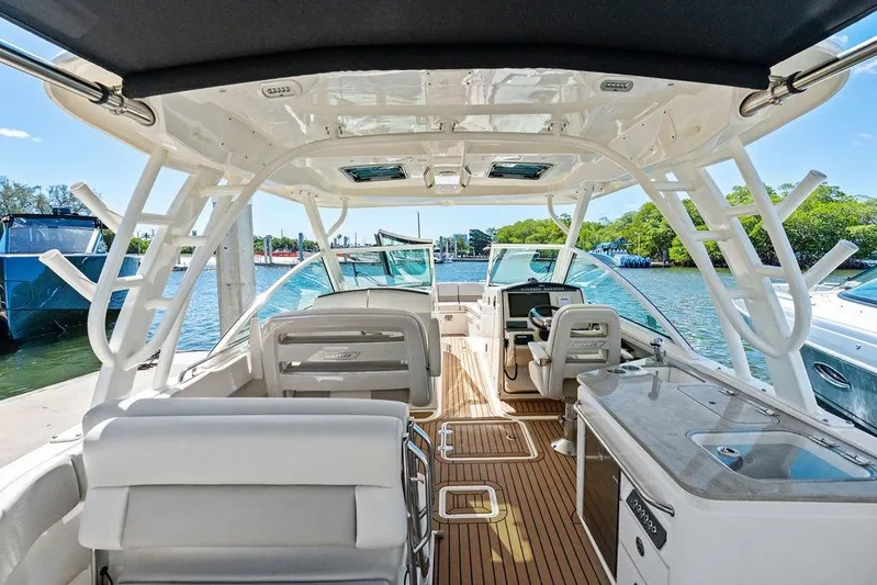 Marmara Yacht Photos Pics 2020 Boston Whaler 320 Vantage boat interior with seating and helm, docked by the water.