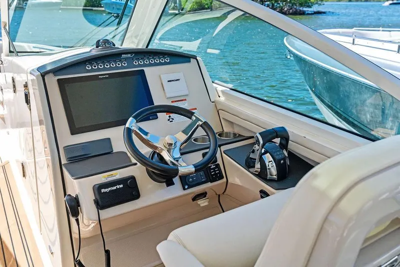 Marmara Yacht Photos Pics 2020 Boston Whaler 320 Vantage helm with Raymarine electronics, steering wheel, and throttle controls.