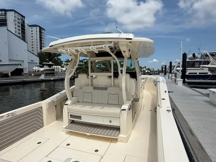  Yacht Photos Pics 2025 Scout 400 LXF luxury boat docked at marina under clear sky.