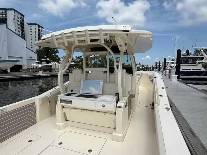  Yacht Photos Pics 2025 Scout 400 LXF boat docked at marina, showcasing spacious deck and modern design.