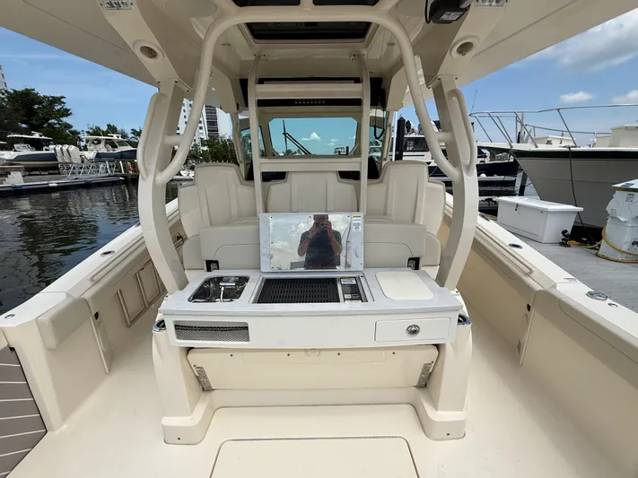  Yacht Photos Pics 2025 Scout 400 LXF boat interior with seating and grill at marina.