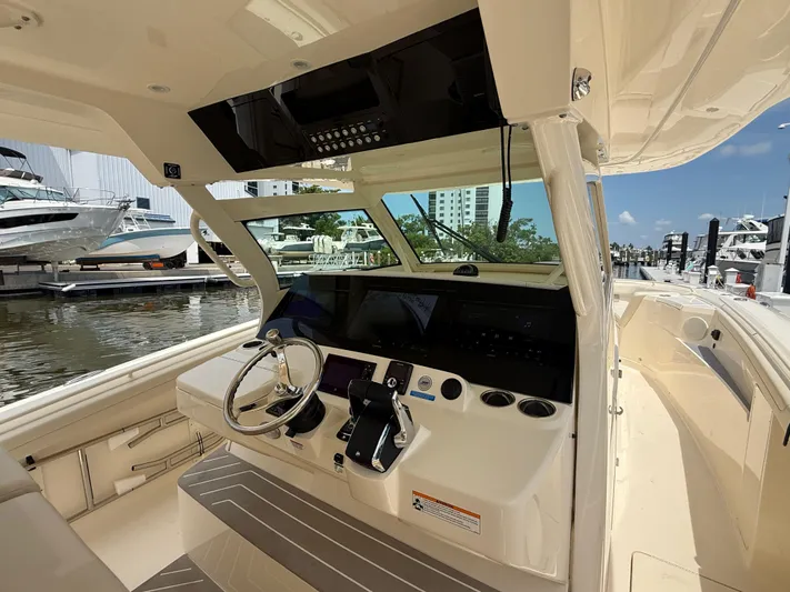  Yacht Photos Pics 2025 Scout 400 LXF boat cockpit with modern steering and navigation controls.