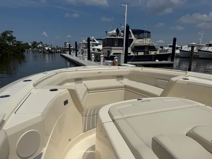  Yacht Photos Pics 2025 Scout 400 LXF boat docked at a marina under a clear blue sky.