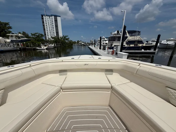  Yacht Photos Pics 2025 Scout 400 LXF boat docked at marina, clear sky, luxury seating.