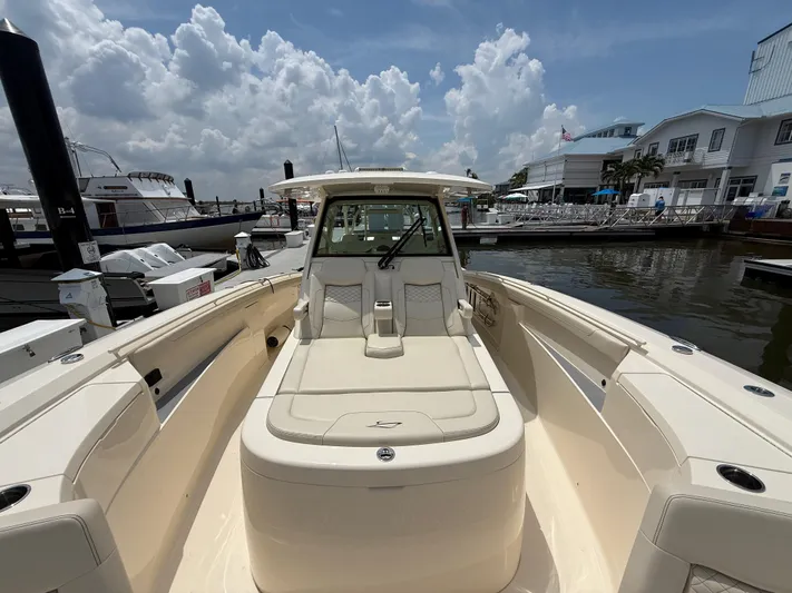  Yacht Photos Pics 2025 Scout 400 LXF boat docked at marina under cloudy sky.