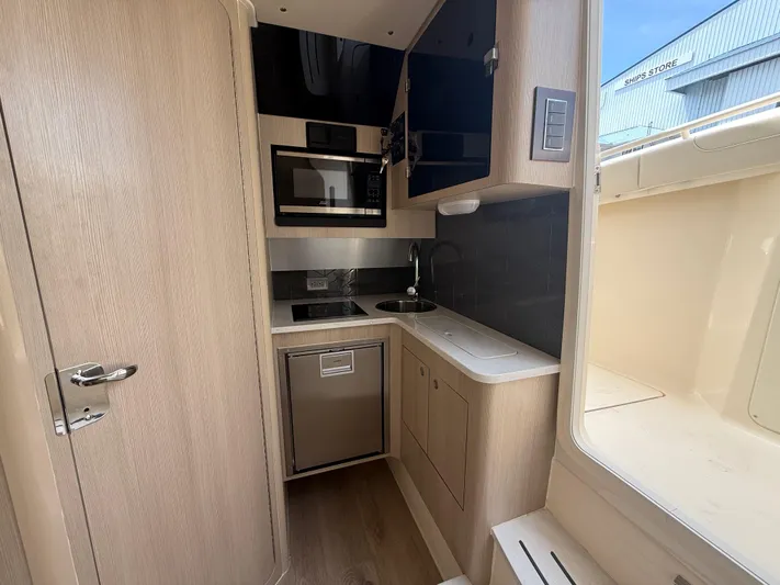  Yacht Photos Pics 2025 Scout 400 LXF yacht interior kitchen with modern appliances and sleek design.