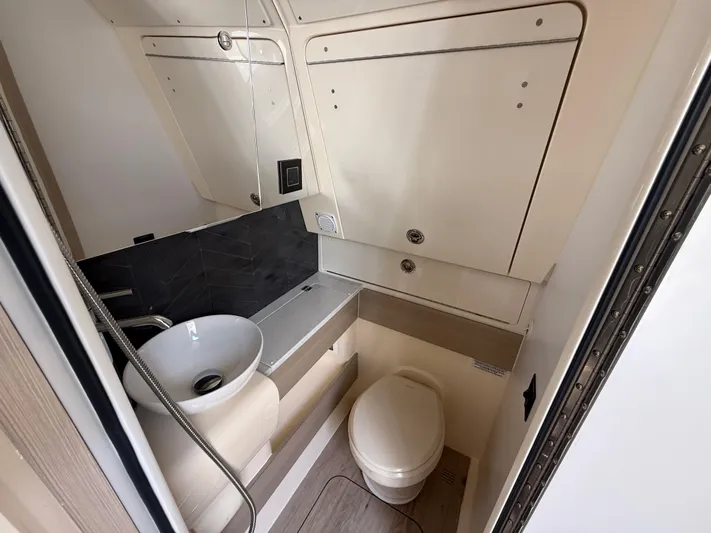  Yacht Photos Pics 2025 Scout 400 LXF boat bathroom with modern sink and toilet.