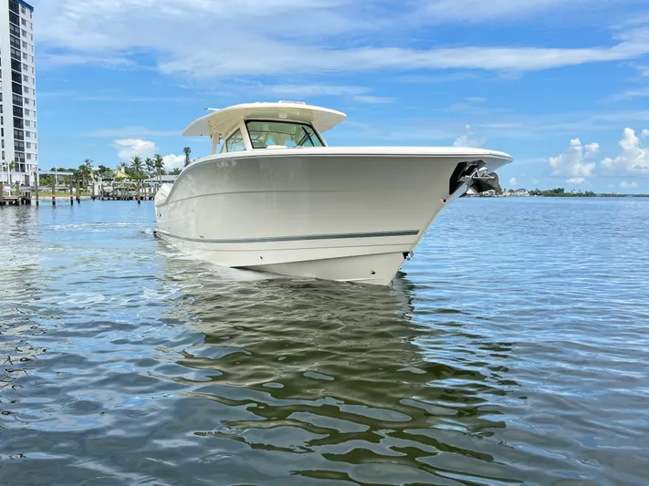  Yacht Photos Pics 2025 Scout 400 LXF boat on calm water, clear sky background.