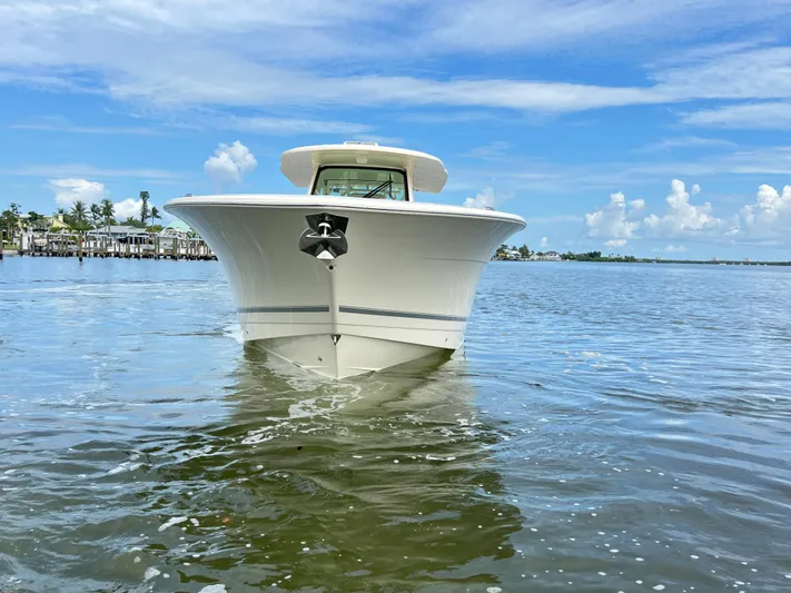  Yacht Photos Pics 2025 Scout 400 LXF boat on calm water under blue sky.