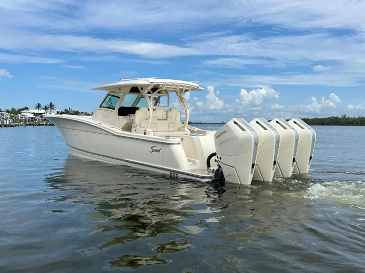  Yacht Photos Pics 2025 Scout 400 LXF boat with four outboard engines on calm water.
