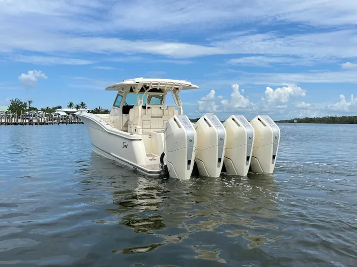  Yacht Photos Pics 2025 Scout 400 LXF boat with four engines on calm water.