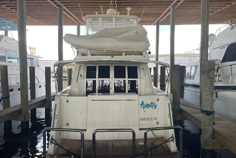 Aventis Yacht Photos Pics 1999 McKinna 57 Pilothouse yacht docked in a marina, rear view.