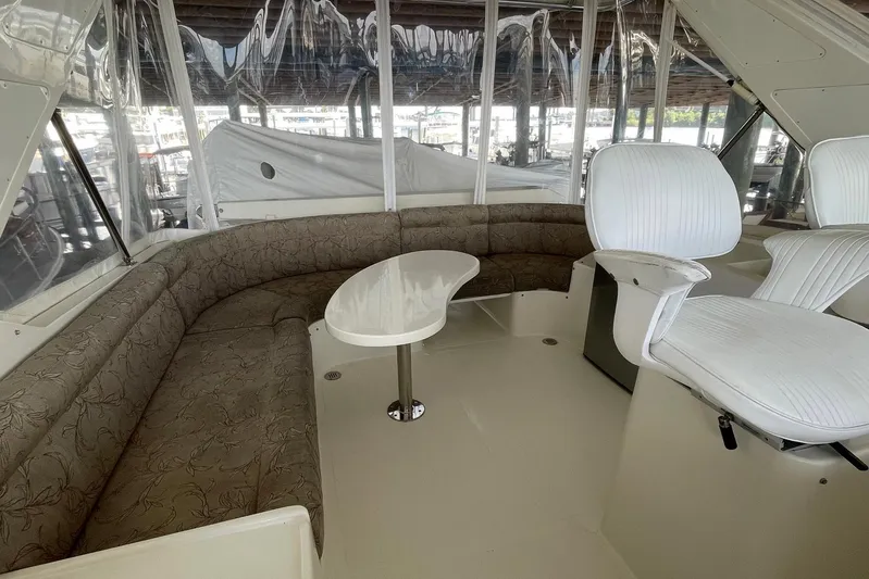 Aventis Yacht Photos Pics 1999 McKinna 57 Pilothouse interior with curved seating and white captain chairs.