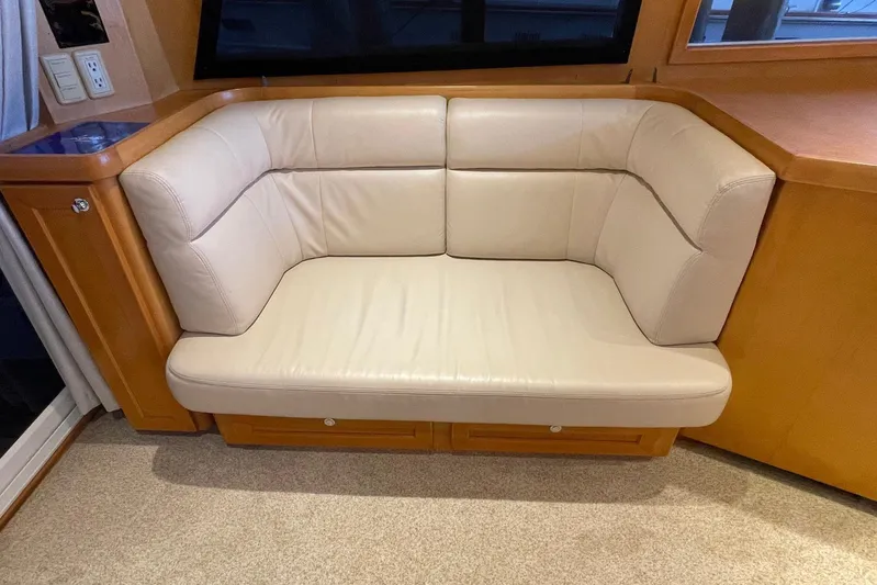 Aventis Yacht Photos Pics Cream leather seating in 1999 McKinna 57 Pilothouse interior, with wooden accents.