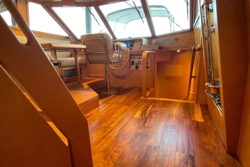 Aventis Yacht Photos Pics 1999 McKinna 57 Pilothouse interior with wooden flooring and helm station.