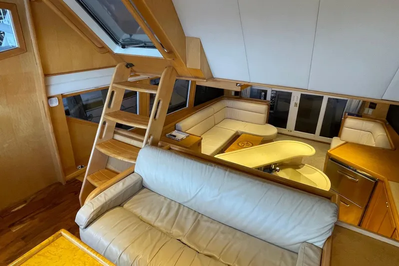 Aventis Yacht Photos Pics Luxurious interior of 1999 McKinna 57 Pilothouse yacht with wooden accents and plush seating.