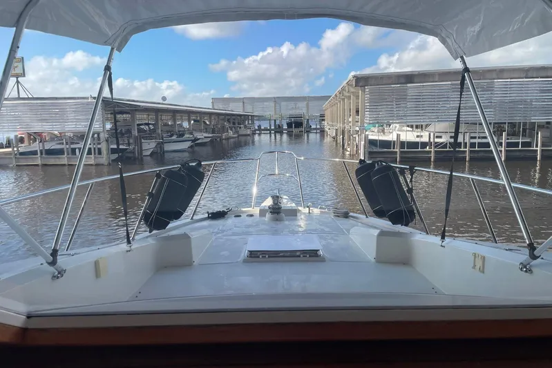 Aventis Yacht Photos Pics 1999 McKinna 57 Pilothouse yacht docked at marina under clear blue sky.