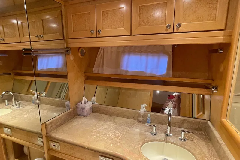 Aventis Yacht Photos Pics Luxurious bathroom interior of 1999 McKinna 57 Pilothouse yacht with wooden cabinetry.