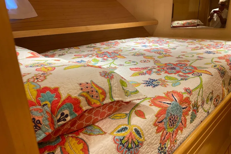 Aventis Yacht Photos Pics Floral bedding in 1999 McKinna 57 Pilothouse cabin, featuring vibrant colors and wooden accents.