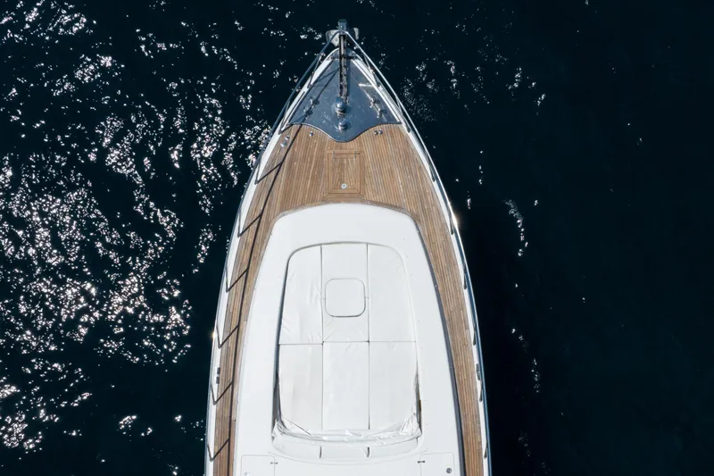  Yacht Photos Pics Aerial view of 2006 Mangusta 80 yacht on dark water, showcasing sleek design.