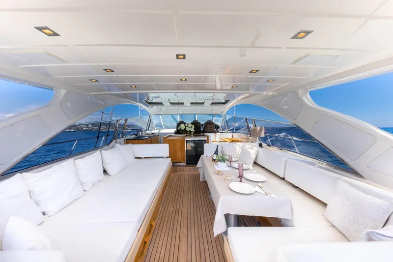  Yacht Photos Pics Luxurious 2006 Mangusta 80 yacht interior with elegant dining setup and ocean view.